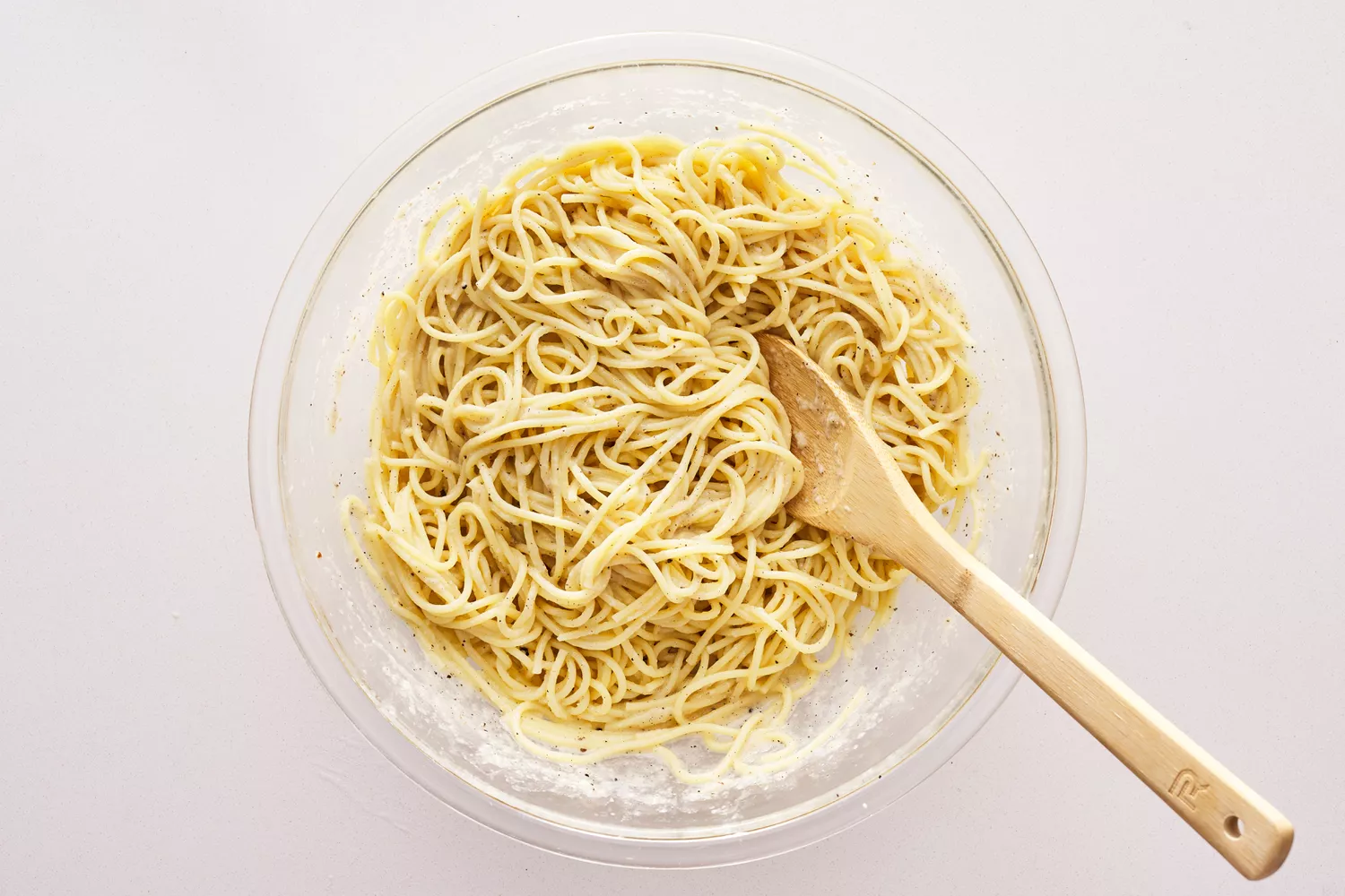 Spaghetti noodles tossed with pecorino sauce.