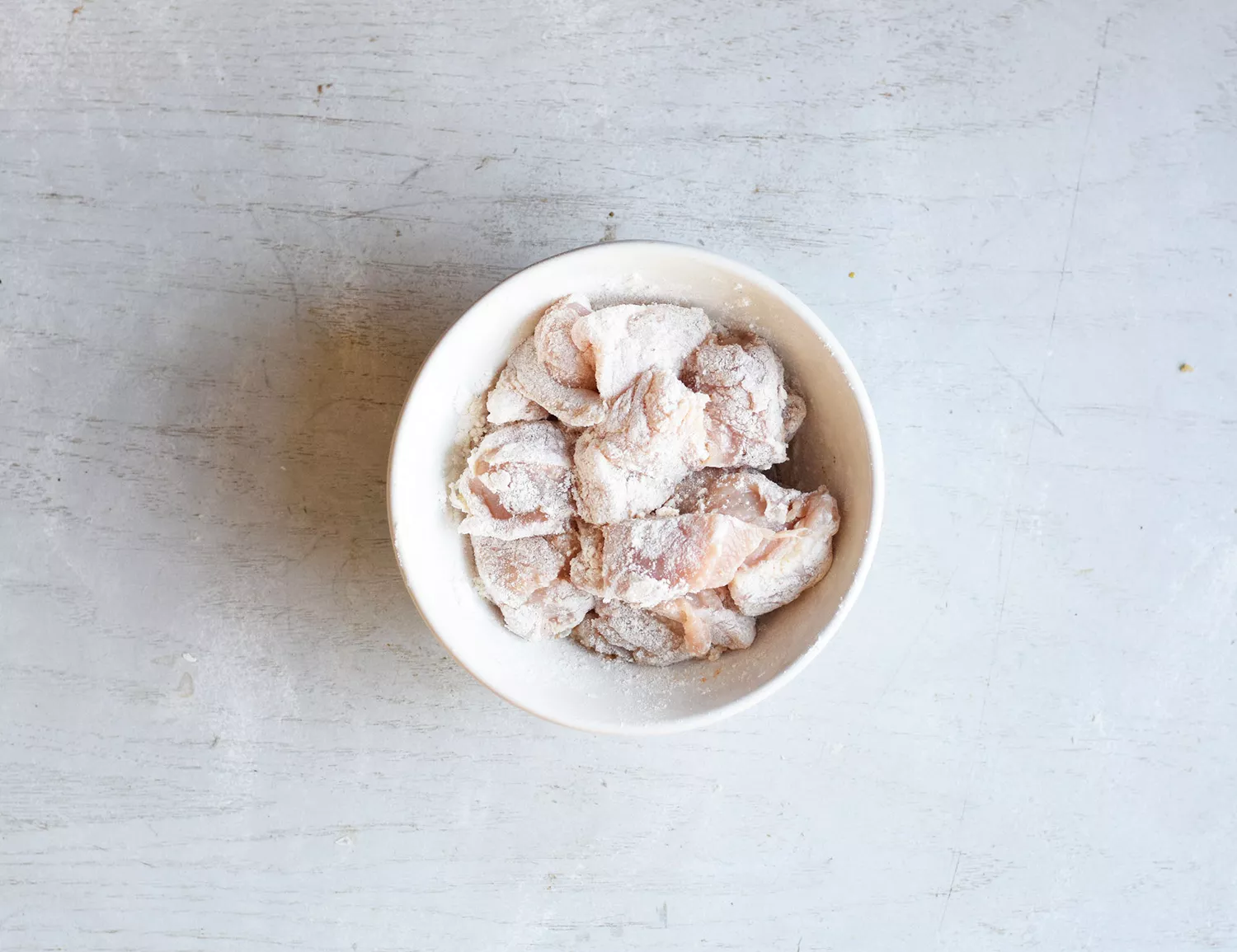 Poulet enrobé de farine dans un bol