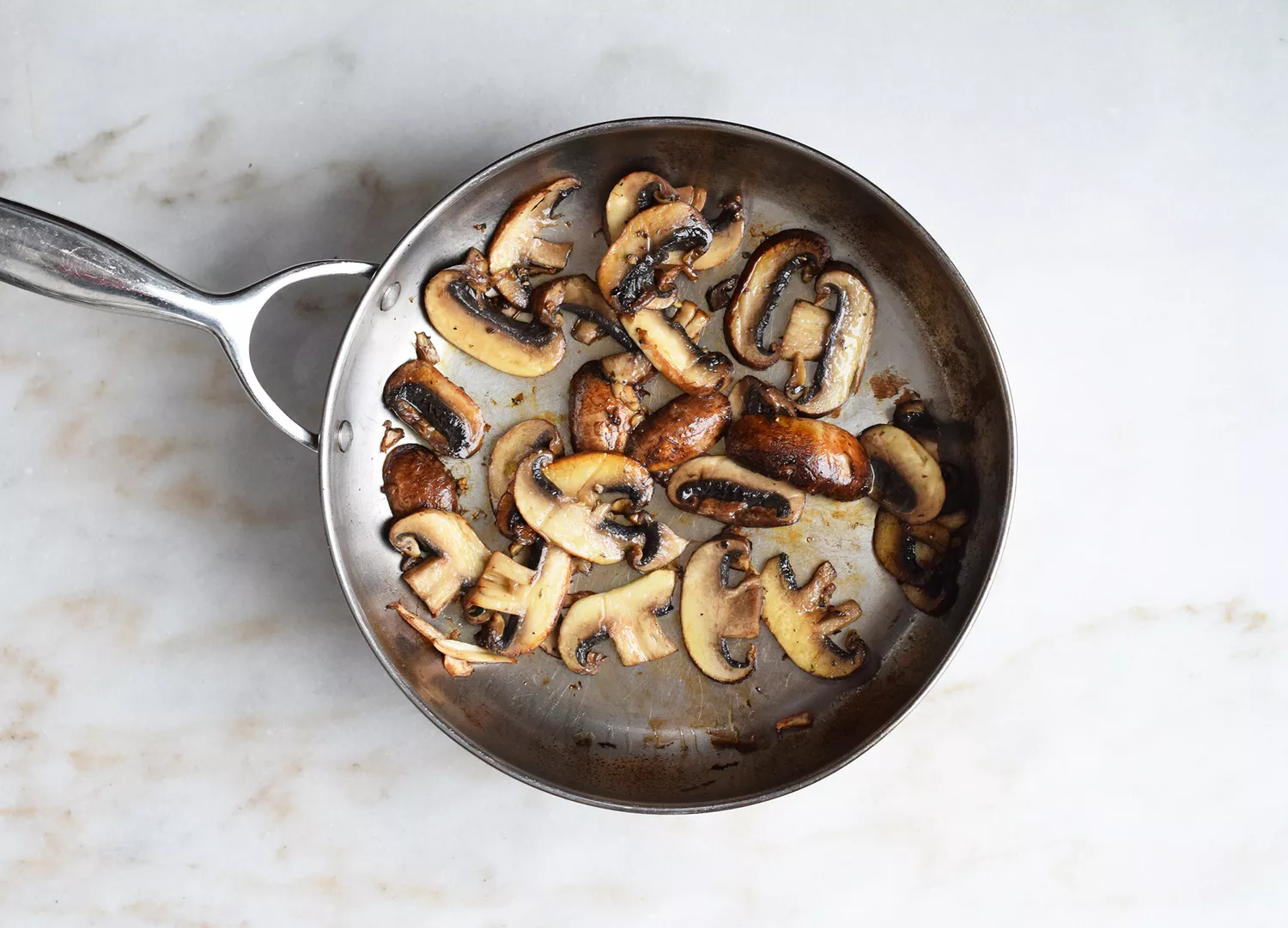 mushrooms sautéing in a skillet