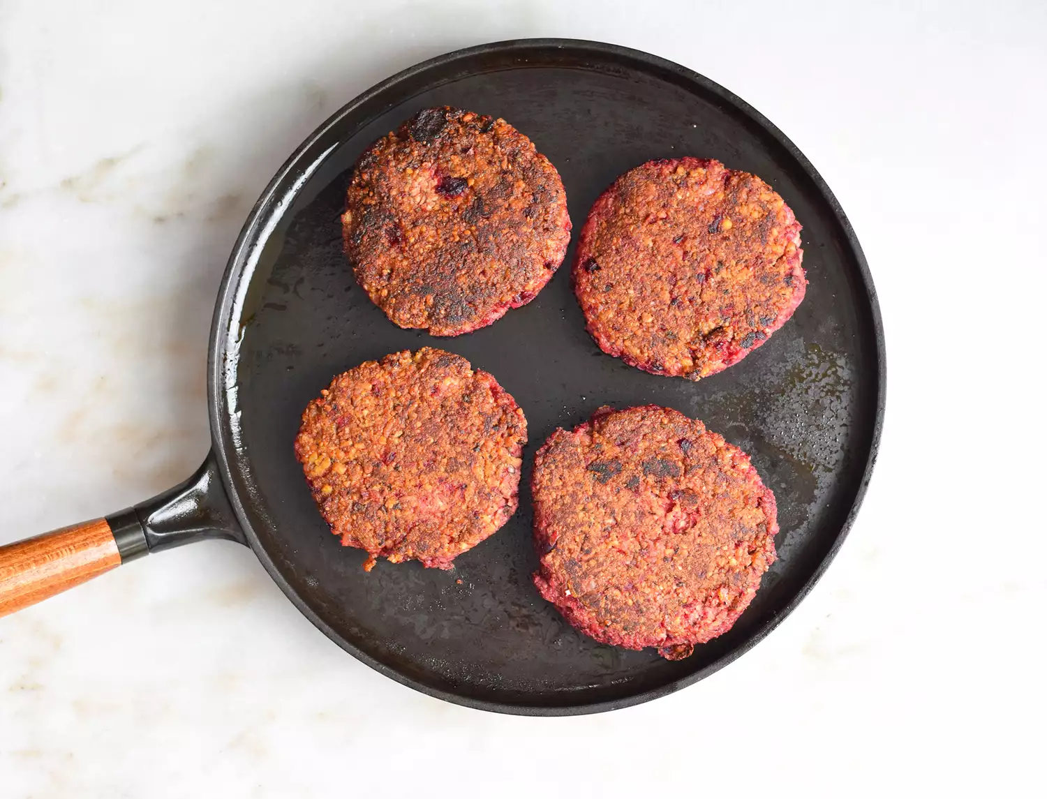 impossible burger patties cooked on a griddle