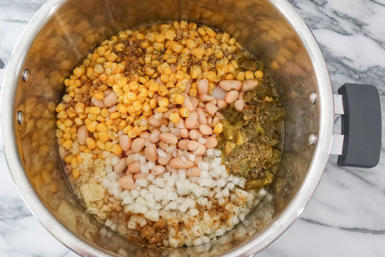 ingredients are combined in the instant pot for white chicken chili