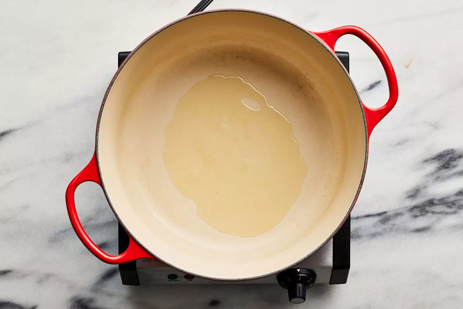 oil heating in heavy bottom pot over burner