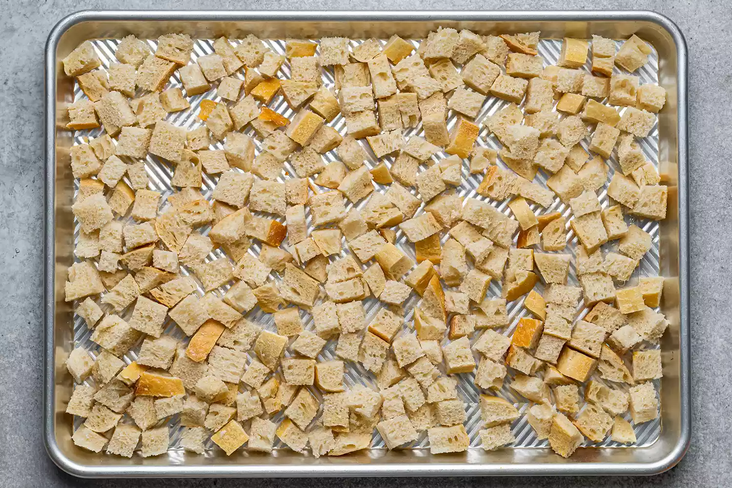 bread cubes on a baking sheet